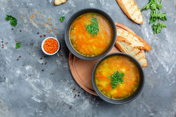 Red lentil soup served with lemon, garlic herbs and spices. Turkish and Indian cuisine. banner, menu recipe place for text, top view