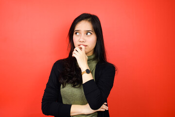 Young beautiful asian women using black sweater with red isolated background