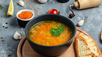 Homemade vegan lentil soup with vegetables. Indian vegetarian cuisine. Food recipe background. Close up