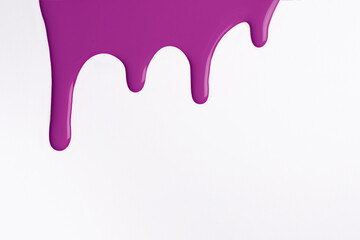 Light purple liquid drops of paint color flow down on isolated white background. Abstract lilac backdrop
