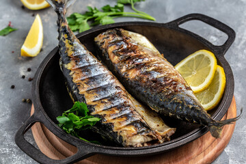 Grilled mackerel fish with lemon herbs and spices, Food recipe background. Close up, top view
