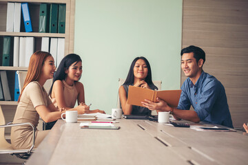 Happiness diversity business team meeting corporate office desk in company meeting room. Asian team group partner brainstorming discussion multiethnic people sitting share ideas teamwork in boardroom