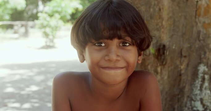 Young Indian from the Pataxo tribe of southern Bahia. Indian child smiling and looking at the camera. 4K.