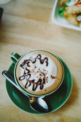 Hot Mocha - A Cup of Coffee with Beautiful Latte Art on wooden table background, Morning Breakfast
