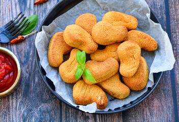 
 Crispy oven baked  chicken nuggets and ketchup. Breaded chicken fillets  with chilly peppers and...