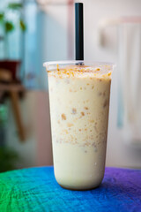 Iced blended caramel coffee topped with crushed caramel biscoff in a plastic glass. Hot season refreshing drinks.