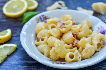  Italian home made   pasta  with  lemon  tuna  fish, parmesan cheese and black pepper .
