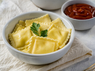 Russian dumplings or Italian ravioli with ketchup and sour cream on a light background. With cheese and mushrooms. Delicious food