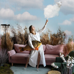 Fantasy concept with a beautiful girl holding a cloud lamb and a fish © Alexey Kuznetsov