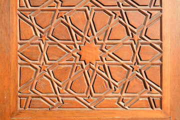 Closeup historical Islamic geometric wooden door decoration detail made with a traditional technique called "kundekari" in Istanbul, Turkey.