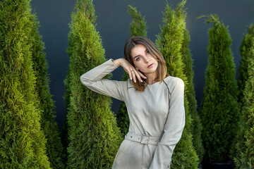 portrait of a young woman near the thuja