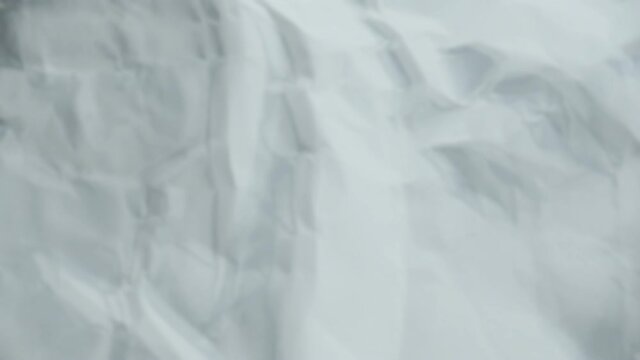 Crumpled sheet of paper. Live wallpaper abstract background. Slow motion. Place for text, title. Can use in vertical position