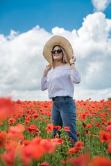 young  woman alone at poppy in field summer day