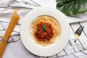 Spaghetti Bolognese, Italian pasta with meat on a white plate - Top view Italian food on marble background
