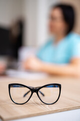 Close up eyeglasses staying at the table. Medical ophtalmology preffesional eyeglasses.