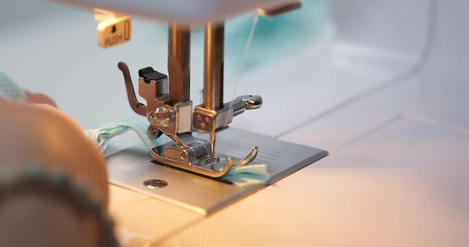 Sewing process, needlework close-up. Tailor makes clothes part with machine. Working in atelier, studio. Clothing fashion designing.