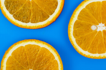 Yellow juicy orange on a blue background. Background on the theme of fruits, citrus fruits.