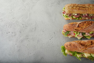 Appetizing sandwiches with various ingredients on table