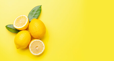 Fresh ripe lemons on yellow background