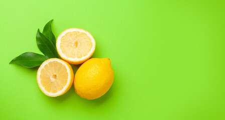 Fresh ripe lemons on green background