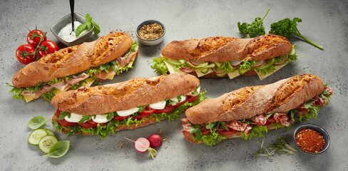 Assorted sub sandwiches with ham and cheese and vegetables
