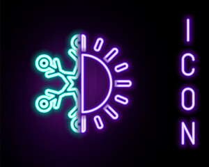 Glowing neon line Hot and cold symbol. Sun and snowflake icon isolated on black background. Winter and summer symbol. Colorful outline concept. Vector