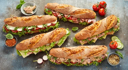 Tuinposter Various sub sandwiches and ingredients on table © exclusive-design