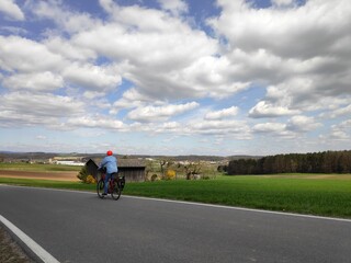 Naklejka premium Beautiful Spring weather near Lichtenfels in Bavaria as people go for a cycle tour