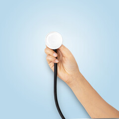 stethoscope held by a woman's hand, Isolated on blue background.