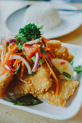 Spicy deep fried catfish salad in the dish put on the table
