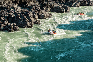 Rafting on a mountain river. Inflatable boats with tourists