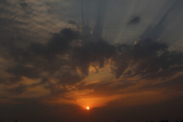 Sun between the clouds at dusk.