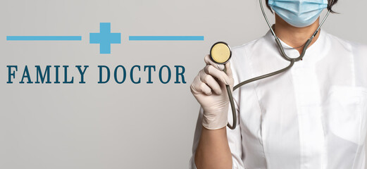 FAMILY DOCTOR - concept of text on gray background. Nearby is a cropped view of doctor with stethoscope