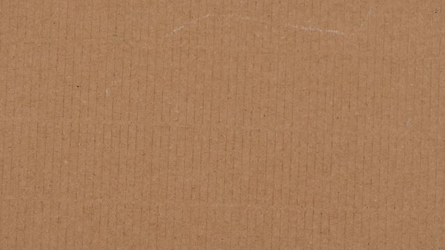 Brown corrugated cardboard paper texture background. Top view. Stop motion animation, 4k video