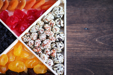 Nuts and dried fruits assortment on stone table top view.