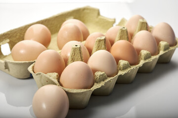 Close-up of eggs in cartoon on white background. Raw chicken eggs in egg box organic food for good health high protein .