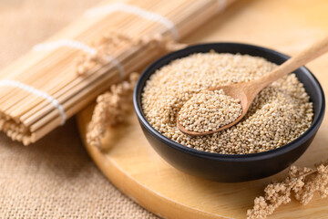 Brown quinoa seeds in a bowl with spoon, Edible seeds are high protein, Healthy food