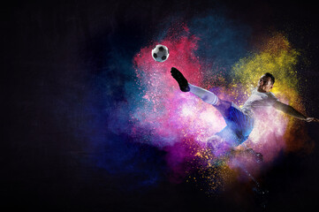 Boy playing soccer hitting the ball