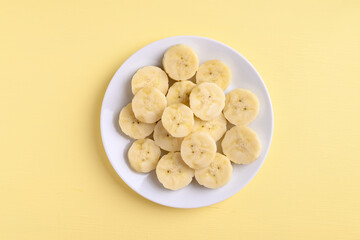 Sliced banana fruit on yellow background, Food ingredients, Tropical fruit