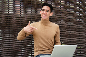 Funny young man with laptop. Freelancer and web design. Business strategy. Online training in the...
