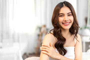 Portrait of smiling cheerful beautiful pretty asian woman clean fresh healthy white skin posing in pajamas white clothes.Girl felling relaxing and enjoy time on the bed at home.asia beauty