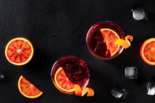 Negroni cocktails with blood oranges and ice, shot from above
