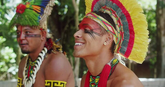 Indian from the Patax&oacute; tribe. Brazilian Indian from the south of Bahia with feather headdress, necklace and traditional facial paintings. 4K.