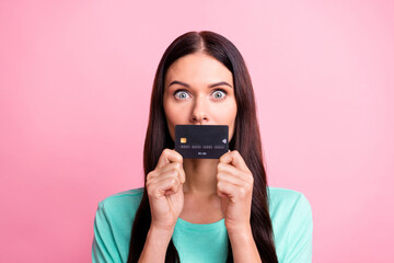 Photo of young attractive lovely pretty voiceless girl cover mouth with credit card isolated on pink color background