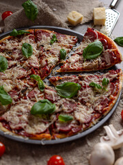 Delicious Italian pizza with mushrooms is served on a wooden table.