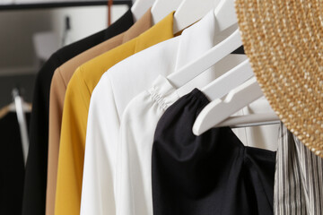 Obraz premium Women's Clothes. Clothes rack with stylish clothes in fashion atelier. Summer wardrobe on a stand. 