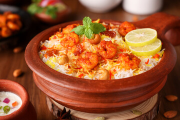 Prawn or shrimp biryani,  Fish biryani. Spicy and delicious Malabar biryani or Hydrabadi biryani, Dum Biriyani, pulao basmati rice, herbs, raitha for Ramadan Kareem, Eid.  Indian food