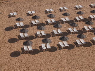 Sun beds and umbrella on the sandy beach