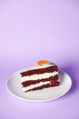 A piece of chocolate cake with vanilla cream. Berries inside and a piece of tangerine on top.