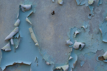 The old cement wall that the paint has dropped.